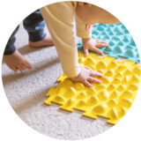 Small baby play with the ribbed rug